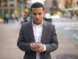 photo of businessman looking at his smart phone