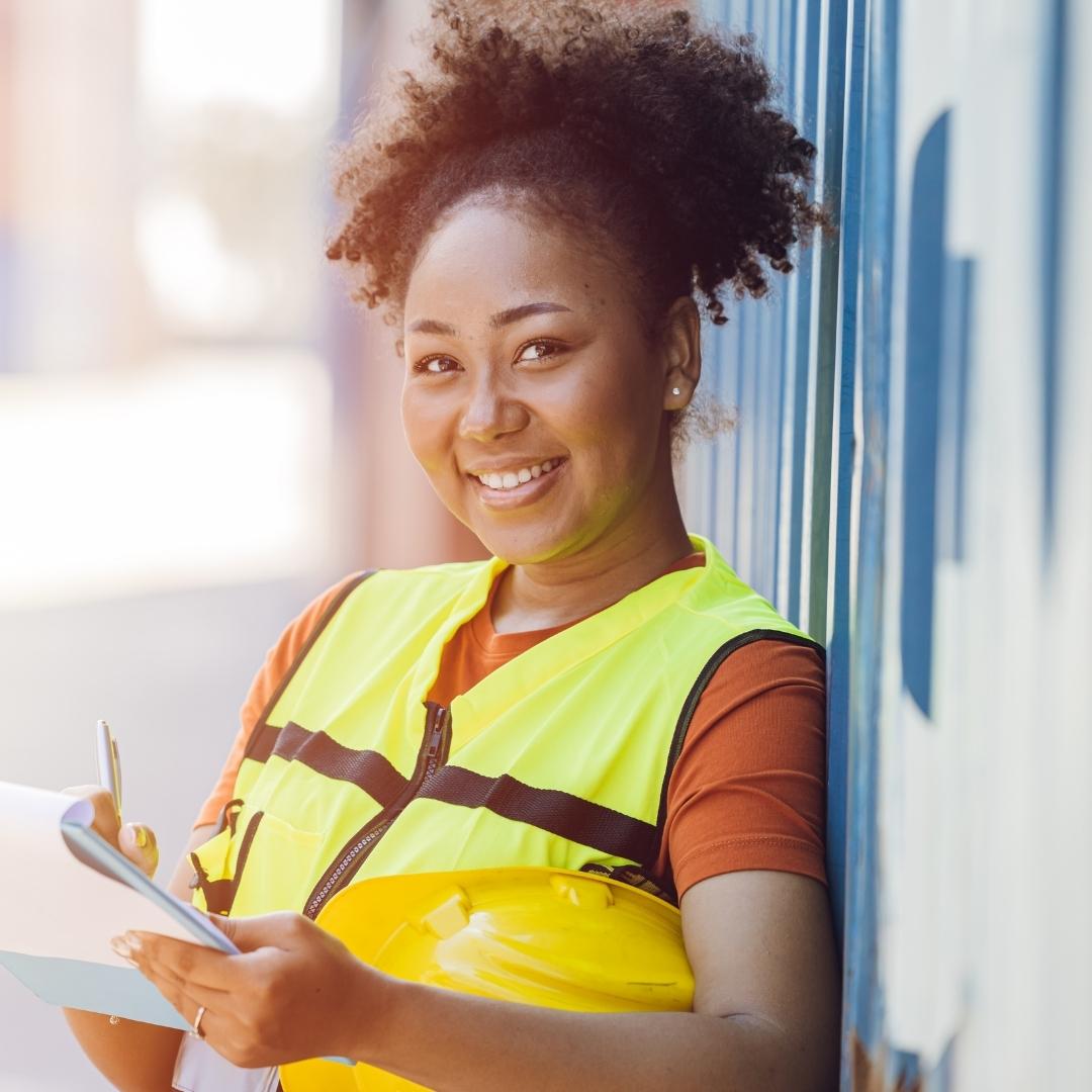 Worker smiling with clip board