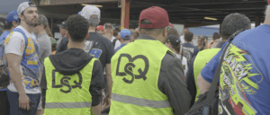 Two security guards, staffed by DQS, helping secure entry at MIS. Read more to learn why DQS is a trusted partner for special event staffing.