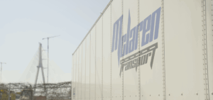 McLaren Transport trailer with the Gordie Howe bridge looming out of focus in the background